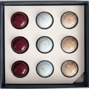 Box of assorted round chocolates in three flavors arranged in a grid.